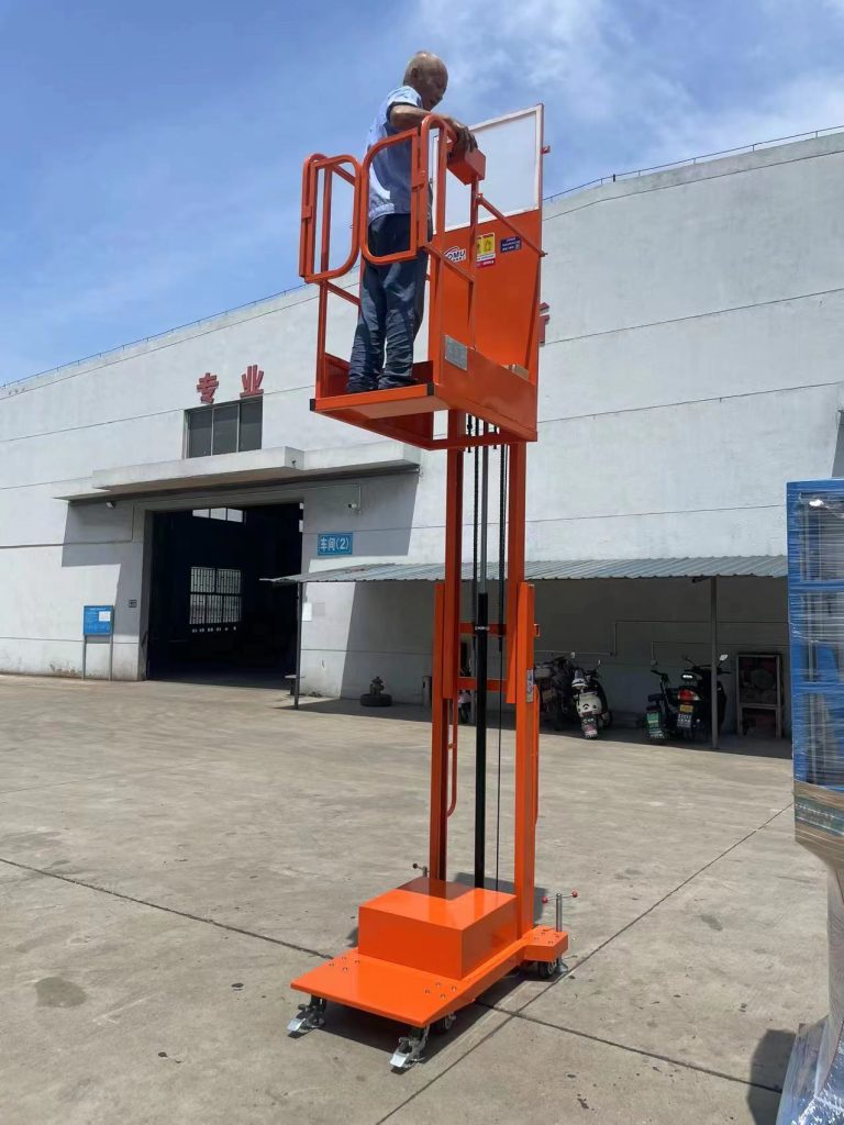 Worker operating electric order picker to retrieve goods from high shelf